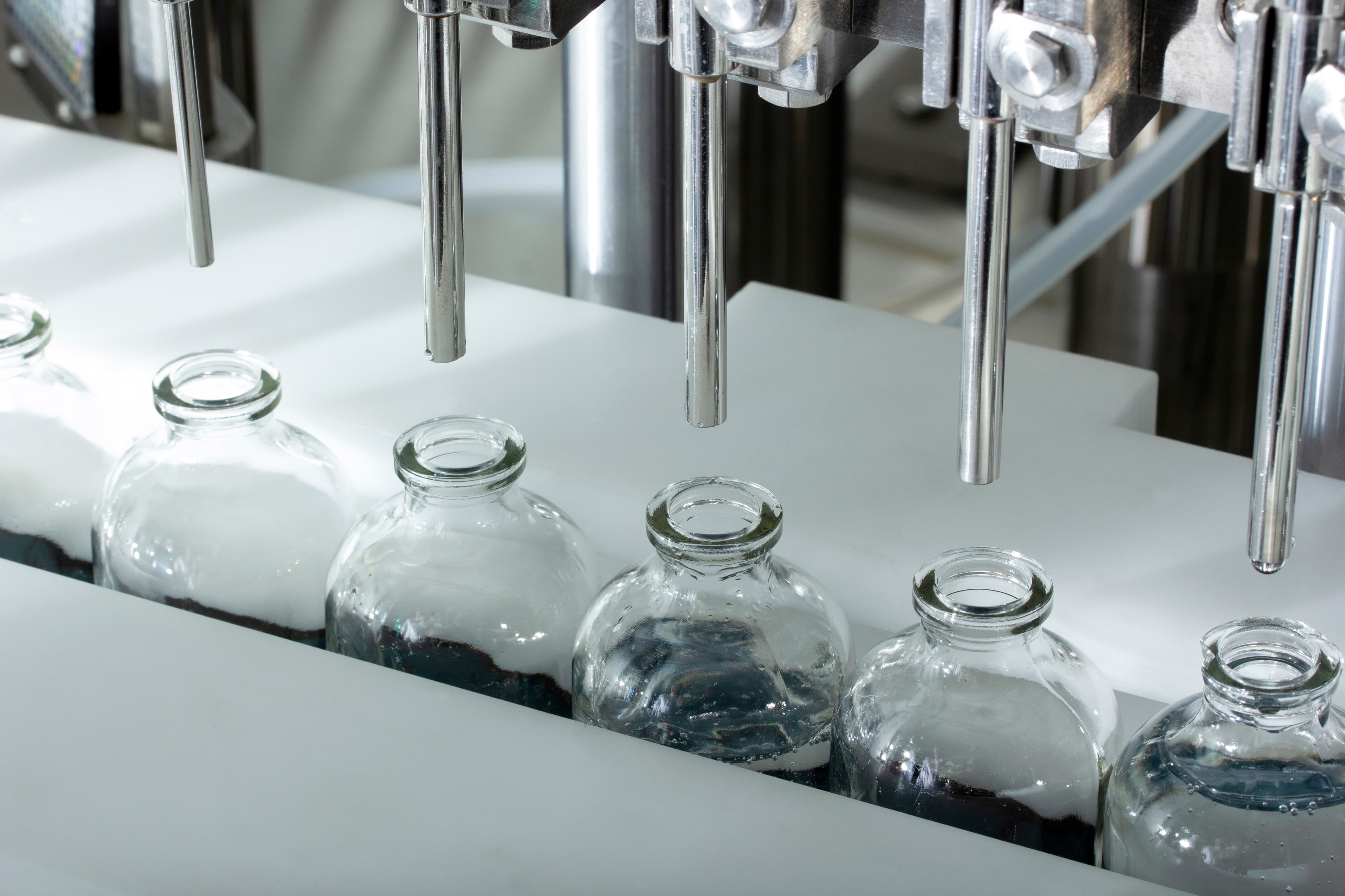 Pharmaceutical bottles moving through a filling line